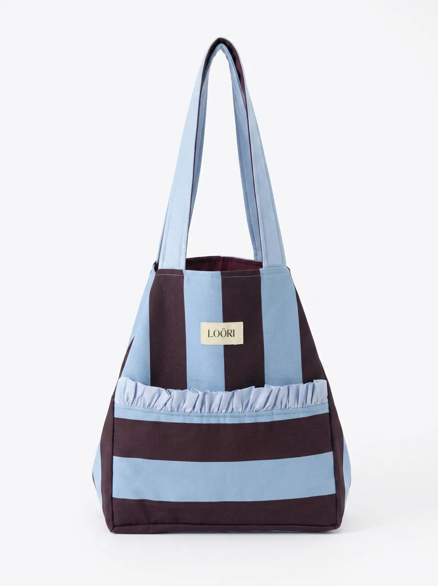 Bolso LOÖRI de rayas anchas en azul claro y burdeos con volante en el bolsillo delantero